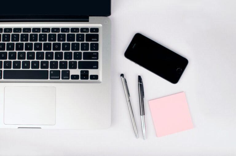 Laptop workspace used to organize practical AI prompts for work