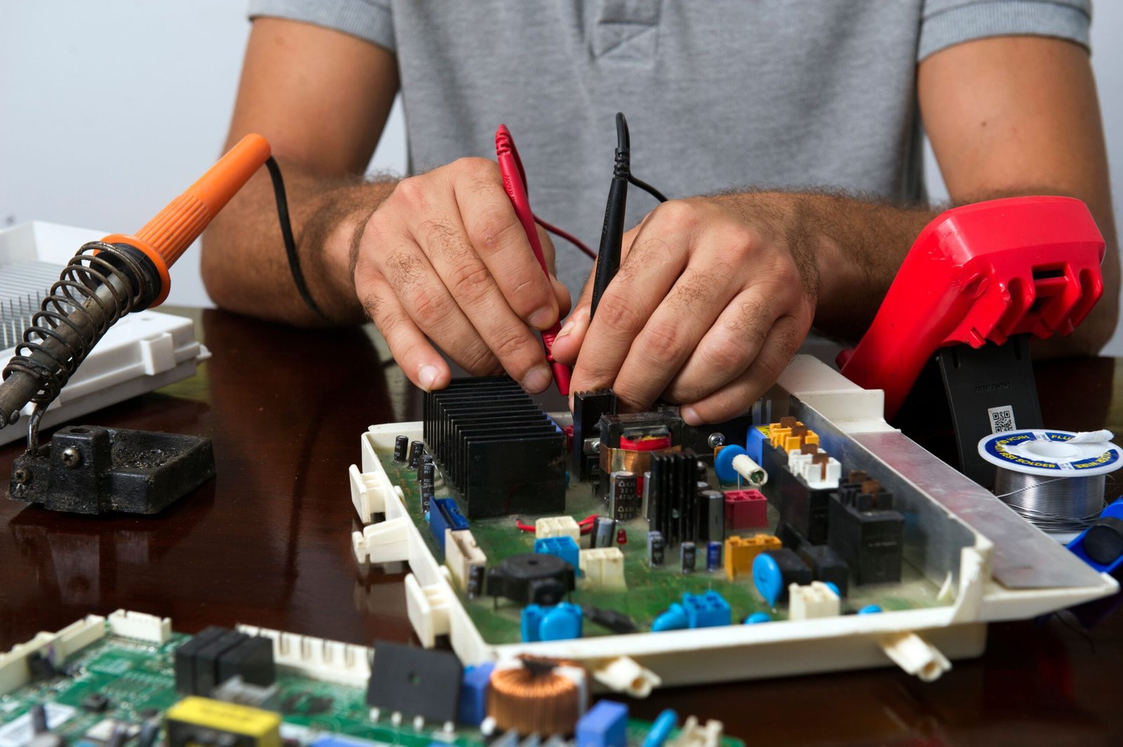Technician repairing electronics with tools for right-to-repair access