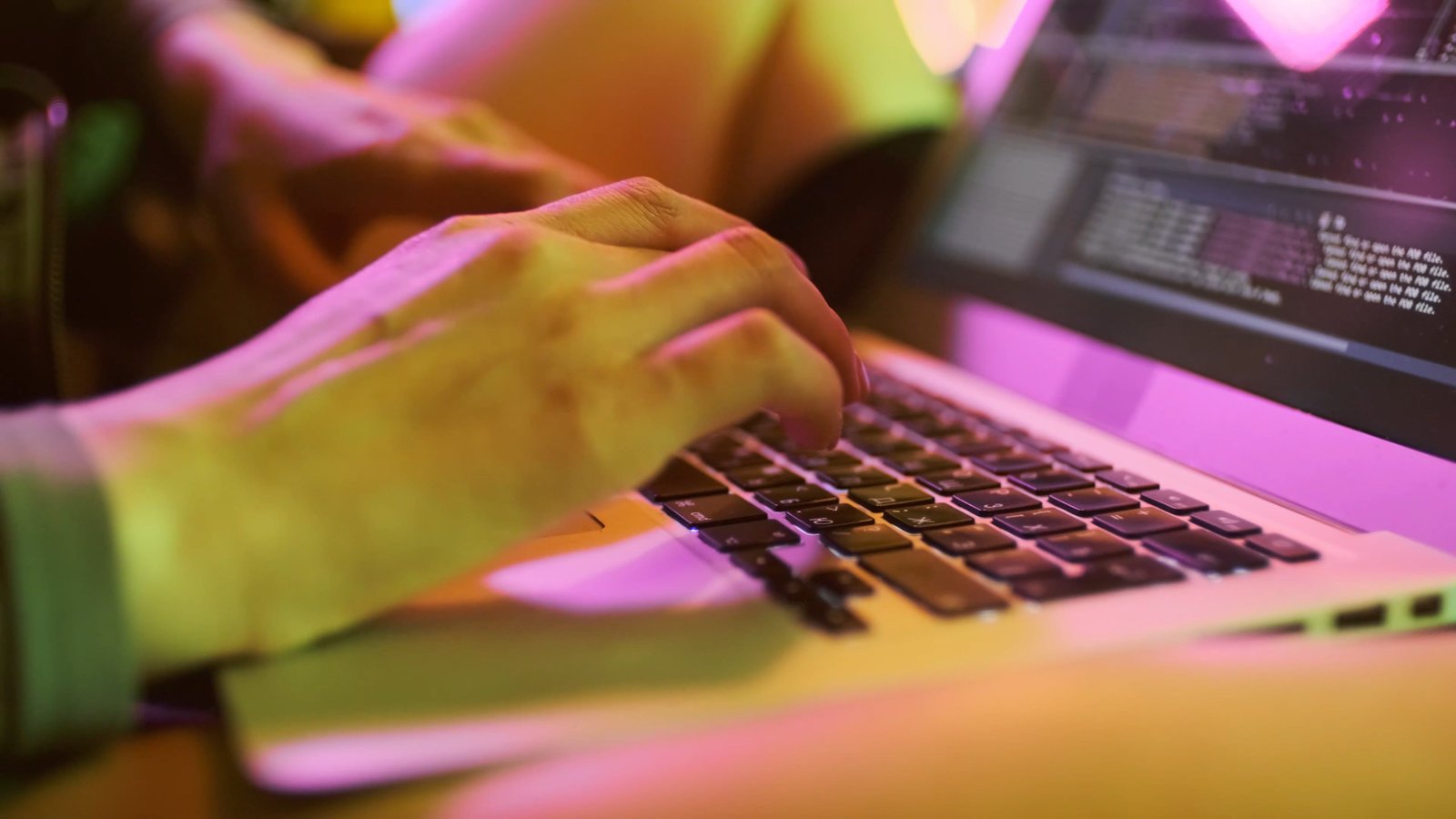 Close-up of typing on a keyboard in a work setup