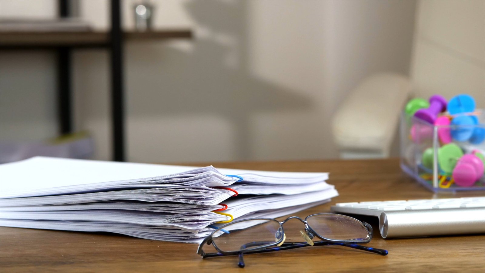 Organized documents and laptop used for report analysis and verification
