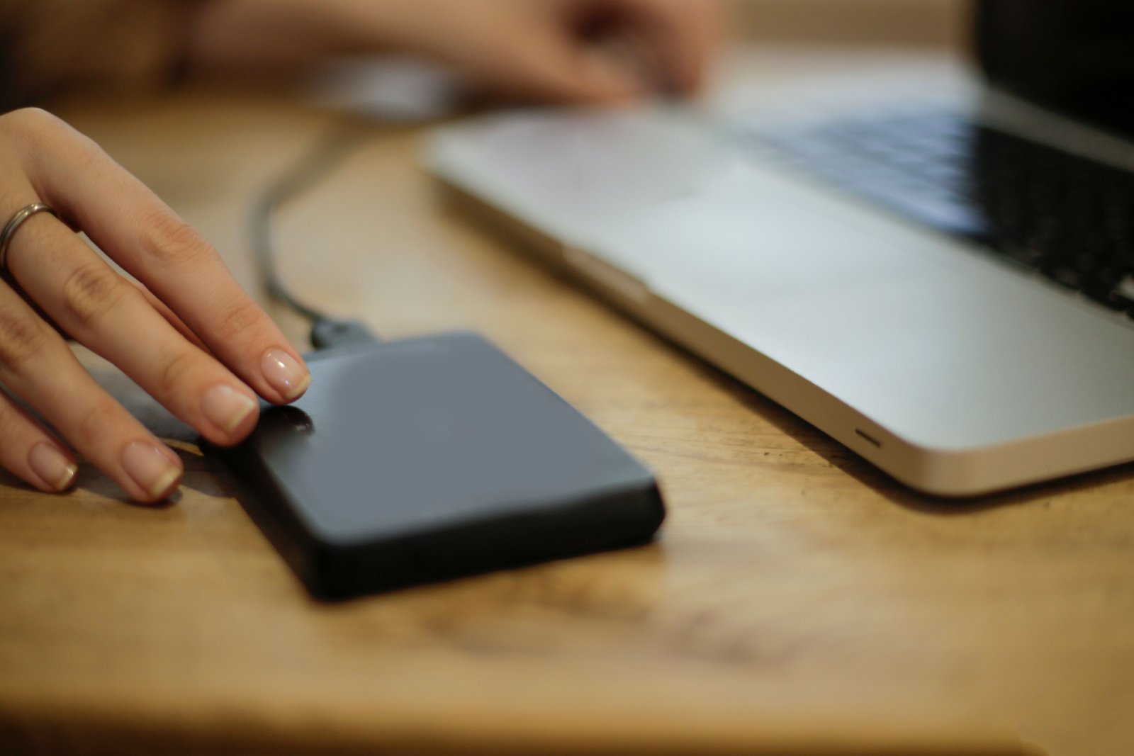 Power bank charging a smartphone on a desk