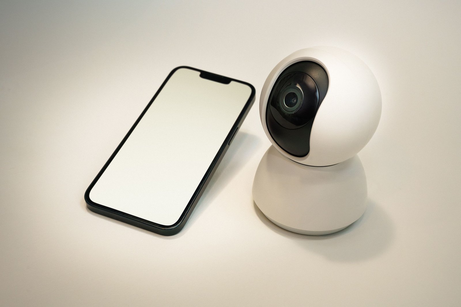 Smartphone and home camera representing remote security monitoring