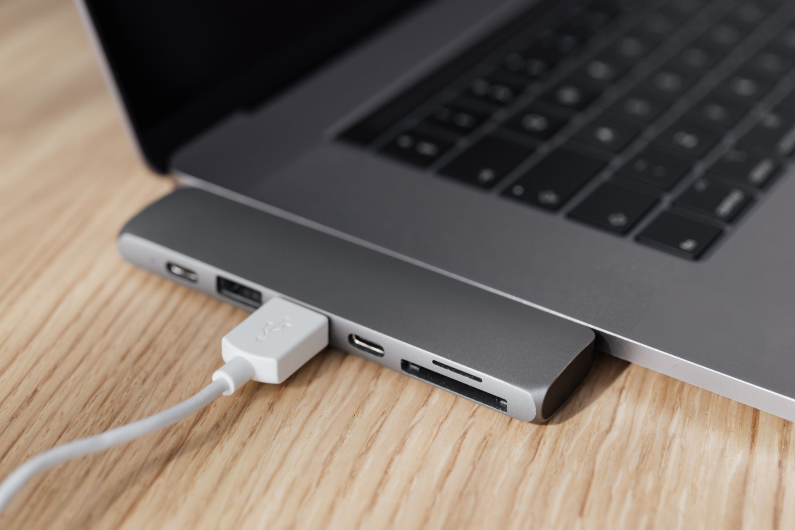 USB-C cable connected to a laptop representing modern USB standards
