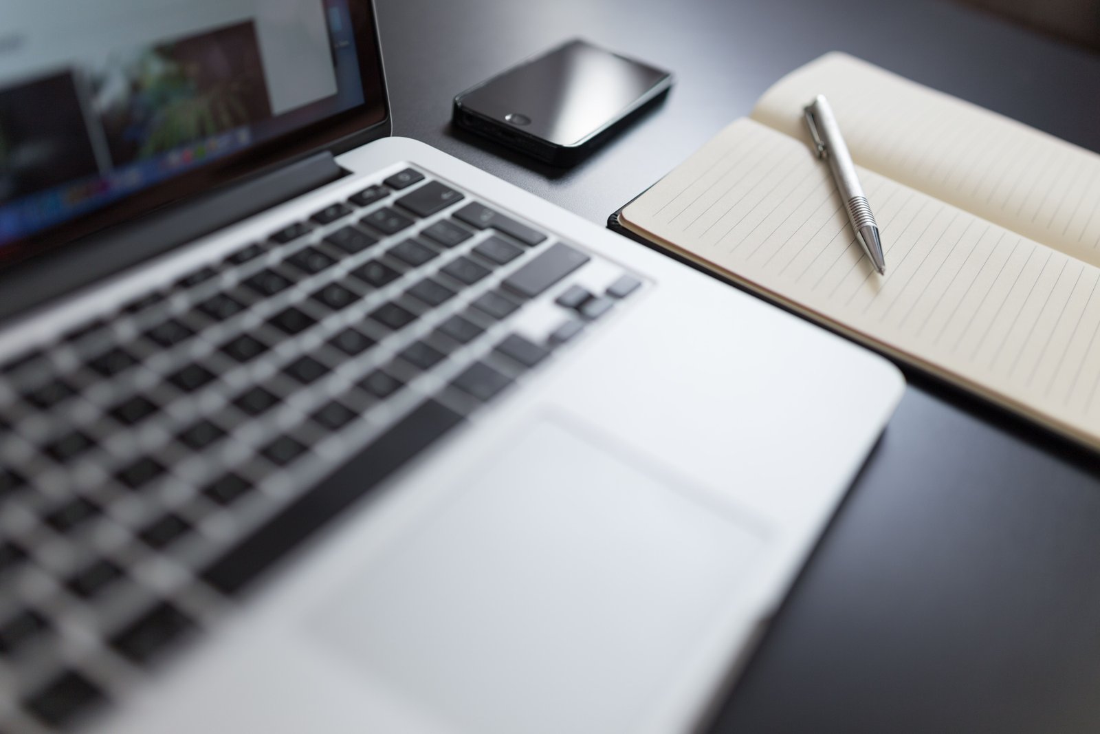 Organized notes and laptop used to build a personal knowledge system