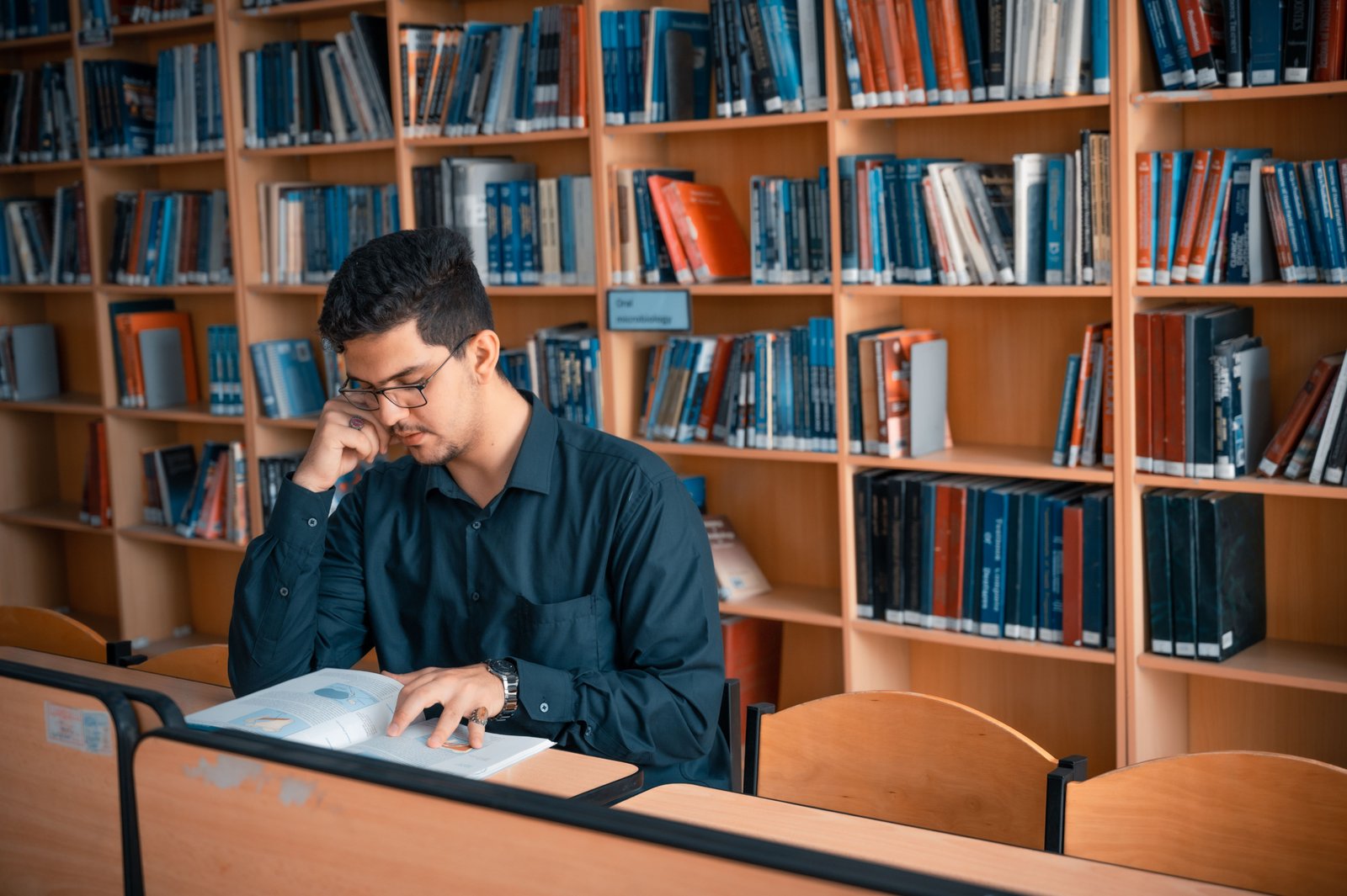 Professional reviewing notes and knowledge resources on a laptop