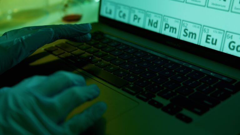 Professional verifying research sources and documents on a laptop