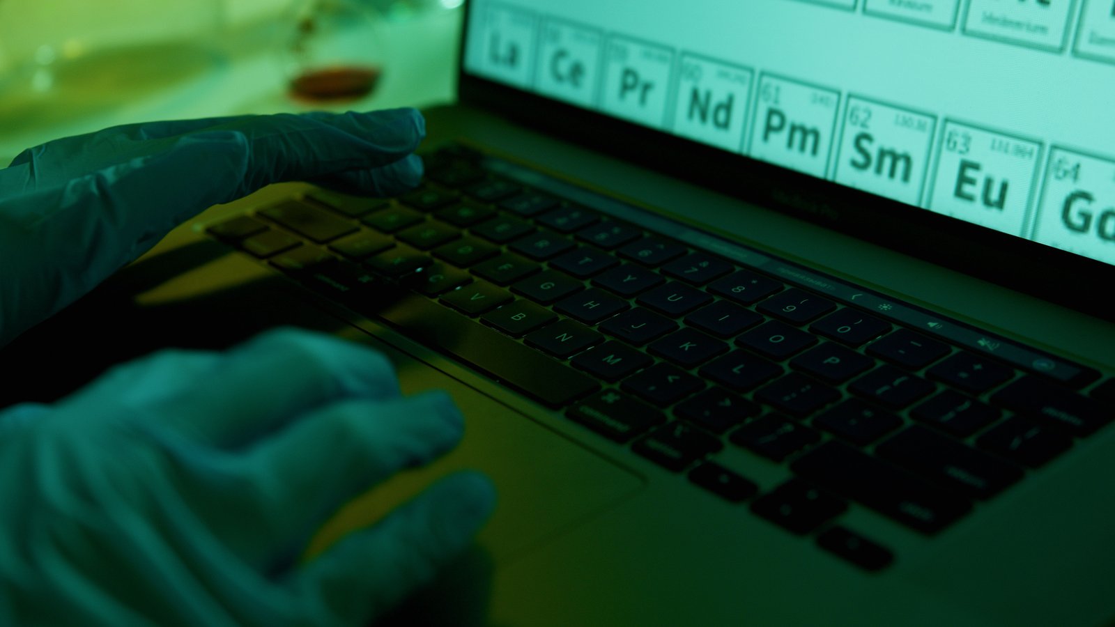 Professional verifying research sources and documents on a laptop